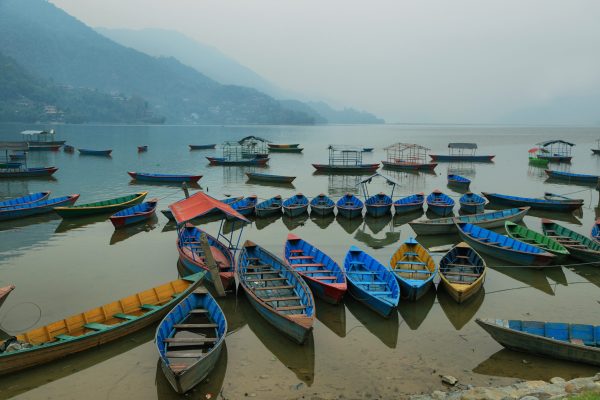 Colorful small boats in the pier of Fewa lake in Pokhara, Nepal