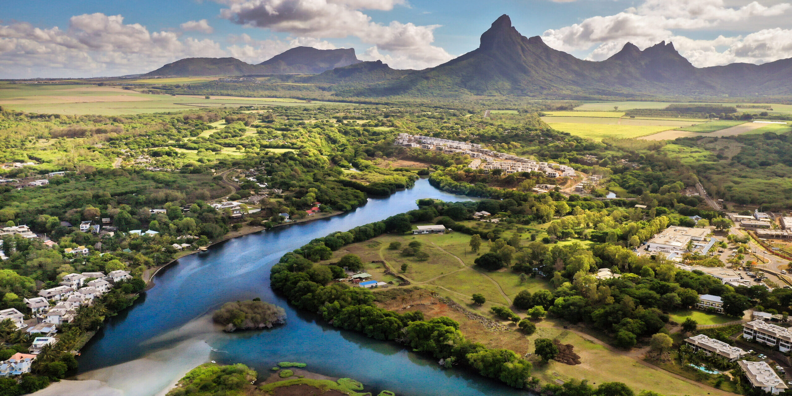 A river flowing into the ocean on the tropical island of Mauritius.Nature on the island of Mauritius, mountains and river of the island of Mauritius